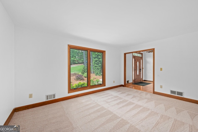 carpeted spare room with baseboards