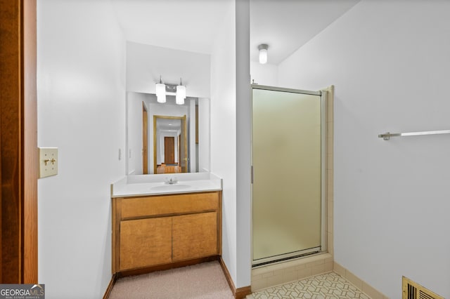 full bathroom with a stall shower, baseboards, vanity, and visible vents