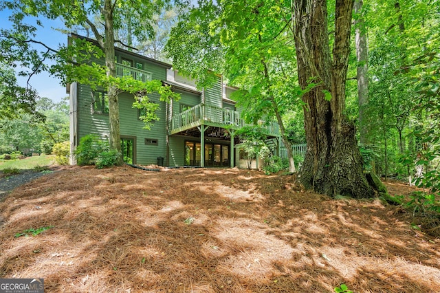 back of property featuring a wooden deck