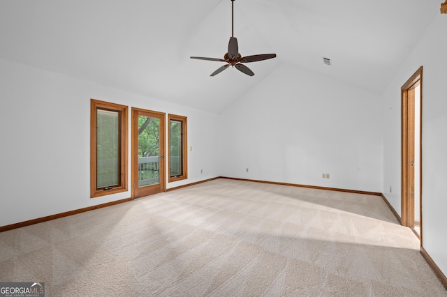 spare room featuring baseboards, visible vents, ceiling fan, vaulted ceiling, and light carpet