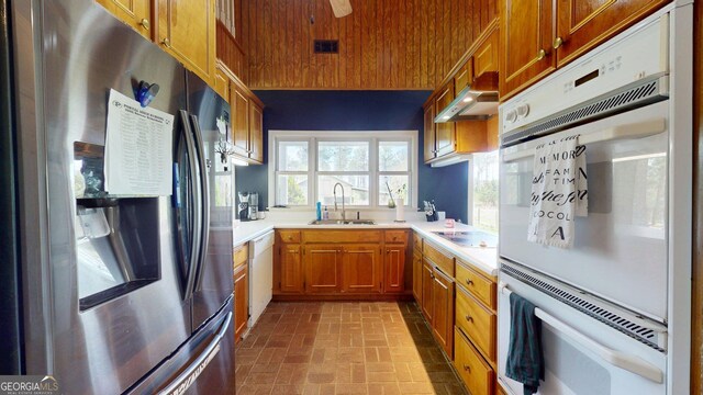 1717 Grady Saunders Rd, Portal, GA 30450 - kitchen featuring visible vents, a sink, brick patterned floor, under cabinet range hood, and white appliances