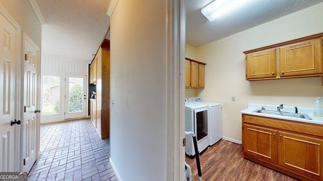 1717 Grady Saunders Rd, Portal, GA 30450 - washroom featuring cabinet space, a sink, a textured ceiling, baseboards, and washer and clothes dryer