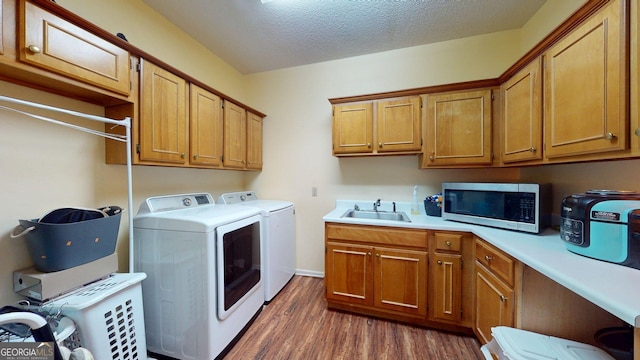 1717 Grady Saunders Rd, Portal, GA 30450 - laundry room with a textured ceiling, washing machine and clothes dryer, dark wood finished floors, cabinet space, and a sink
