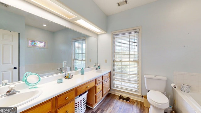 1717 Grady Saunders Rd, Portal, GA 30450 - bathroom featuring a sink, double vanity, toilet, visible vents, and a bath