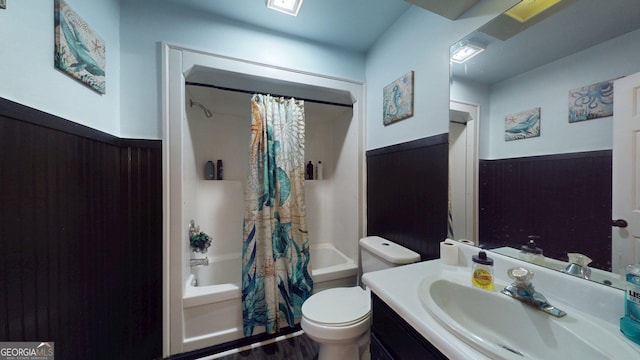 1717 Grady Saunders Rd, Portal, GA 30450 - bathroom featuring vanity, wood finished floors, shower / bath combination with curtain, toilet, and a wainscoted wall