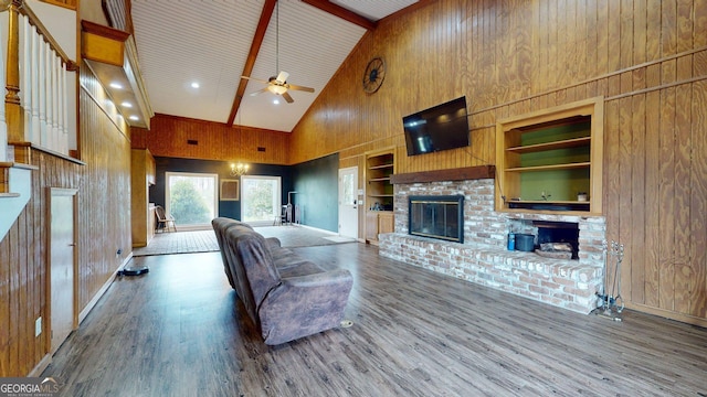 1717 Grady Saunders Rd, Portal, GA 30450 - living area with a ceiling fan, built in features, a fireplace, wood finished floors, and high vaulted ceiling