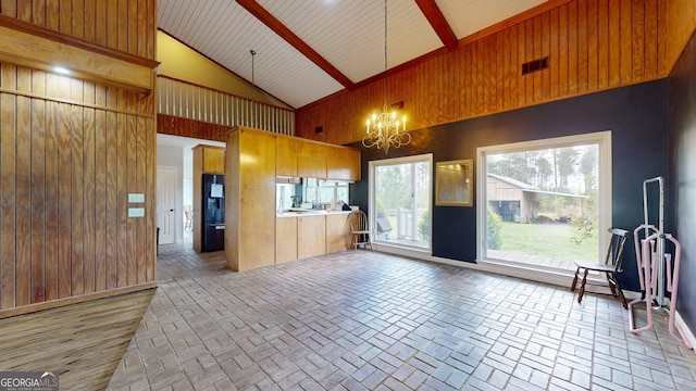 1717 Grady Saunders Rd, Portal, GA 30450 - kitchen with visible vents, brick patterned floor, high vaulted ceiling, a chandelier, and black refrigerator
