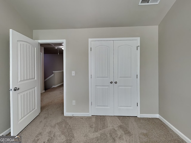 1392 Worcester Trl, Mcdonough, GA 30253 - unfurnished bedroom featuring attic access, carpet, baseboards, and a closet