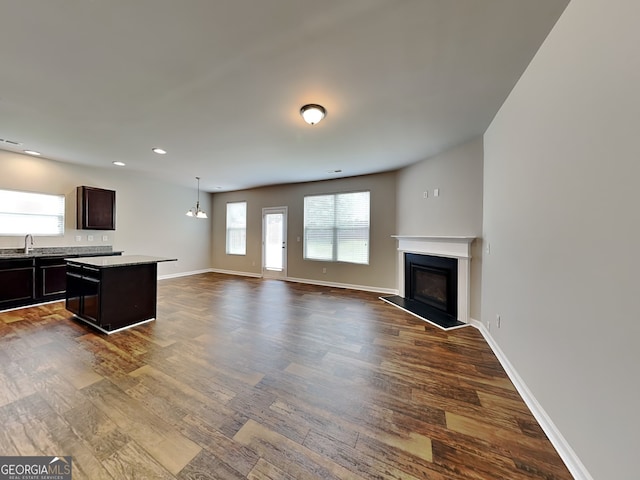 1392 Worcester Trl, Mcdonough, GA 30253 - unfurnished living room with a fireplace with raised hearth, dark wood finished floors, recessed lighting, and baseboards