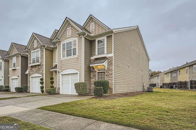 1963 Lakeshore Overlook Cir NW, Kennesaw, GA 30152 - view of property featuring an attached garage, concrete driveway, a front lawn, and stone siding