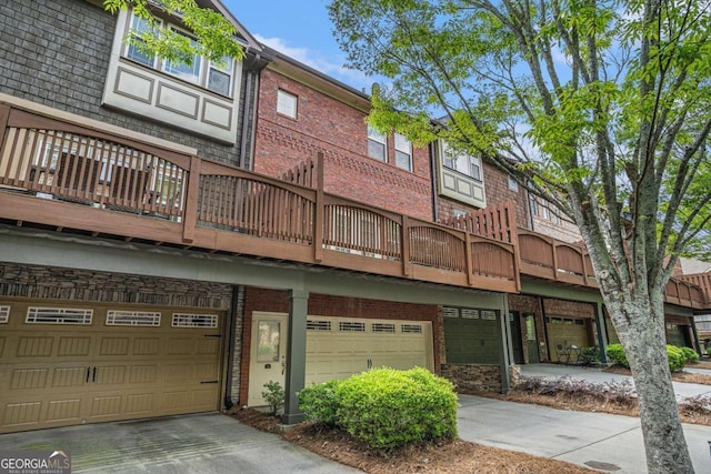 75 High Top Ln, Sandy Springs, GA 30328 - rear view of house featuring a garage, driveway, a balcony, and brick siding