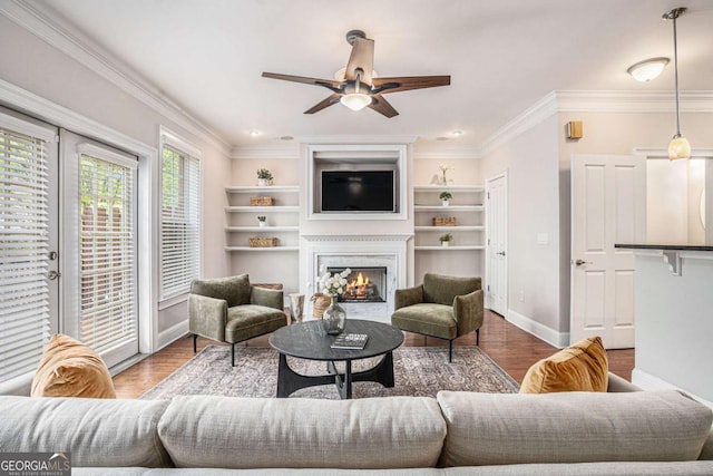 75 High Top Ln, Sandy Springs, GA 30328 - living room featuring a lit fireplace, wood finished floors, a ceiling fan, ornamental molding, and built in features