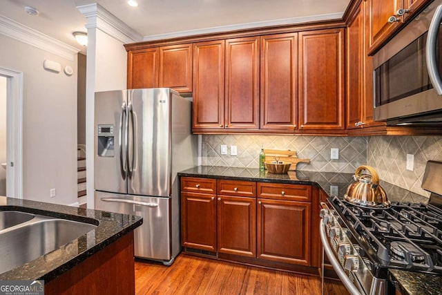 75 High Top Ln, Sandy Springs, GA 30328 - kitchen featuring stainless steel appliances, wood finished floors, ornamental molding, dark stone countertops, and tasteful backsplash