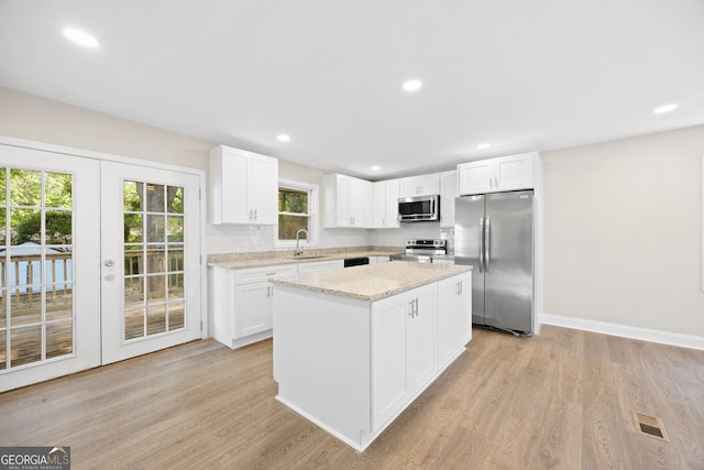 2805 Long Way, Decatur, GA 30032 - kitchen with stainless steel appliances, a sink, a center island, light wood-style flooring, and recessed lighting