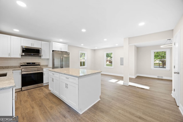 2805 Long Way, Decatur, GA 30032 - kitchen with appliances with stainless steel finishes, backsplash, light wood-style floors, white cabinetry, and recessed lighting