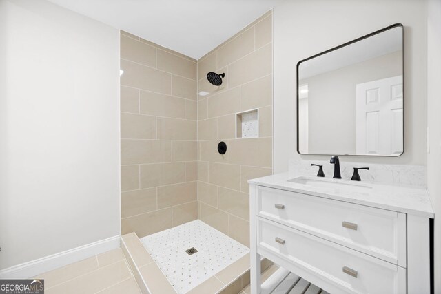 full bath featuring vanity and tiled shower