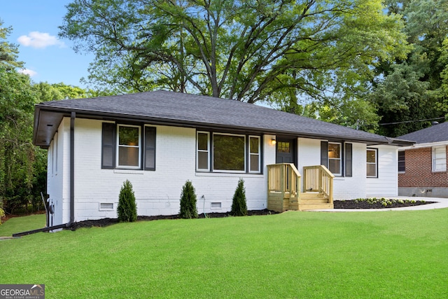 single story home featuring brick siding, crawl space, a shingled roof, and a front lawn