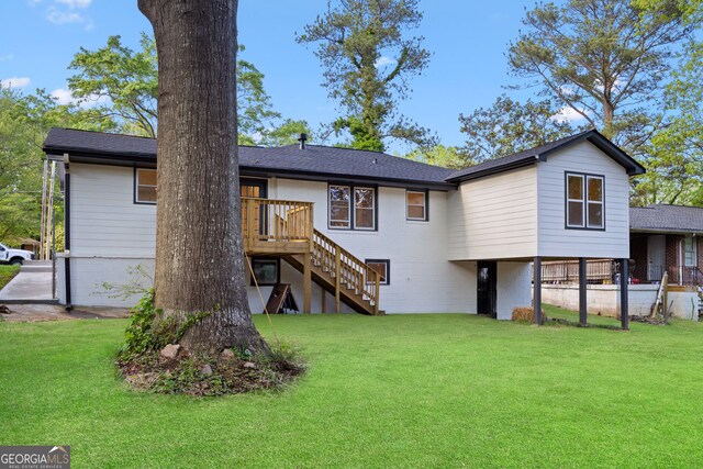 back of house featuring stairway, a yard, and a wooden deck
