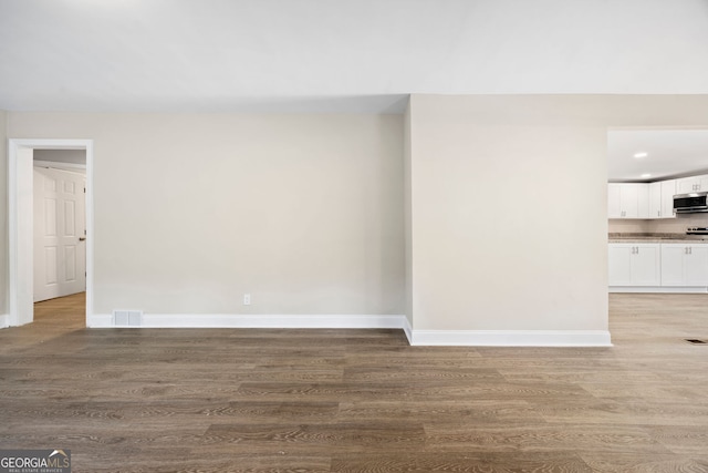 2805 Long Way, Decatur, GA 30032 - unfurnished living room featuring light wood finished floors, baseboards, and recessed lighting