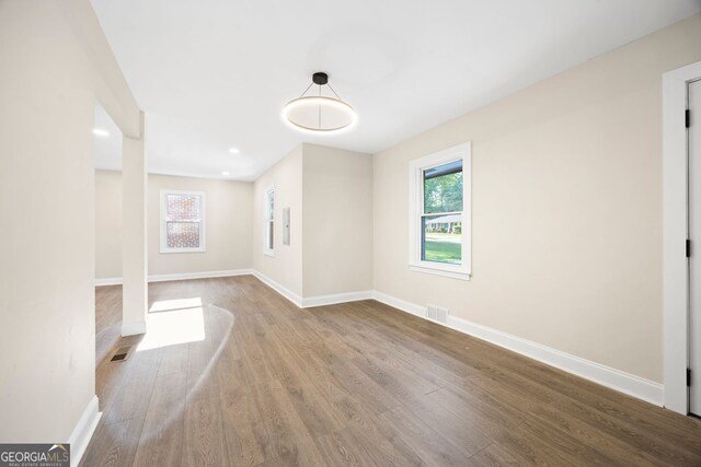 interior space featuring visible vents, wood finished floors, and a healthy amount of sunlight