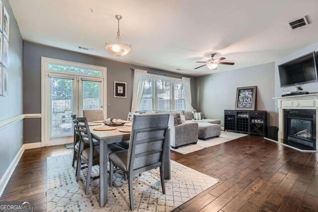 dining area with baseboards, ceiling fan, dark wood-style floors, and visible vents