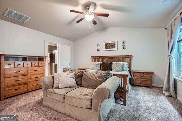 carpeted bedroom with a ceiling fan, visible vents, baseboards, a spacious closet, and lofted ceiling