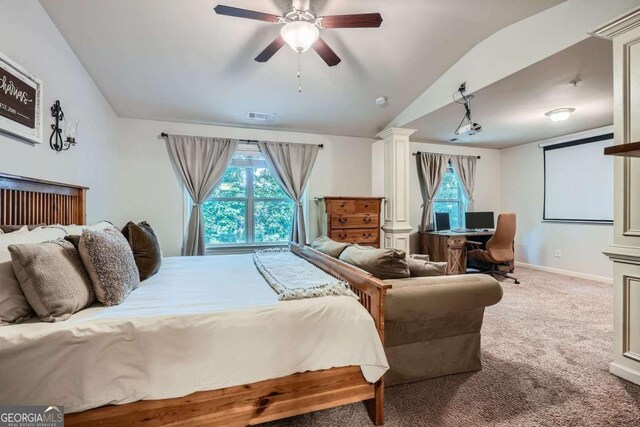 carpeted bedroom with multiple windows, a ceiling fan, vaulted ceiling, and visible vents