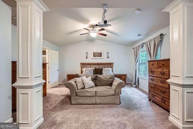 bedroom featuring visible vents, decorative columns, baseboards, light colored carpet, and vaulted ceiling