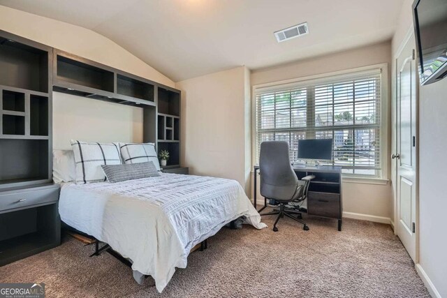 carpeted bedroom featuring visible vents, baseboards, and vaulted ceiling