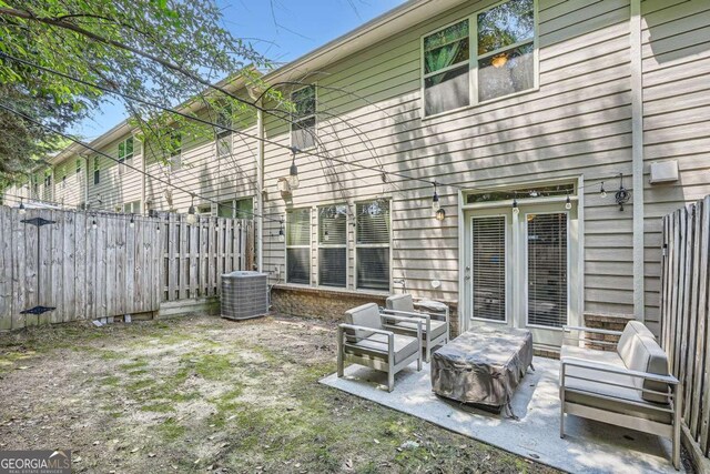 rear view of property with a patio area, fence, and cooling unit