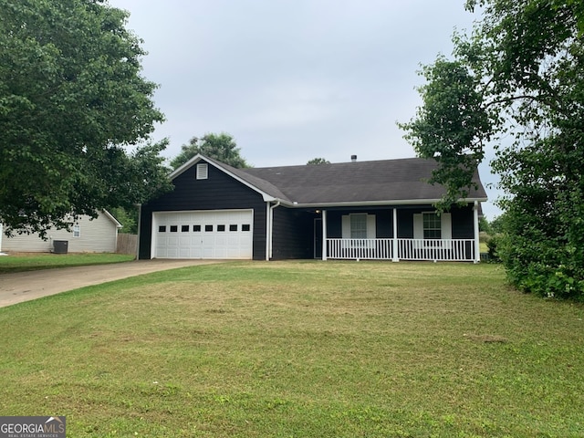 ranch-style house featuring a porch, a front lawn, an attached garage, and concrete driveway