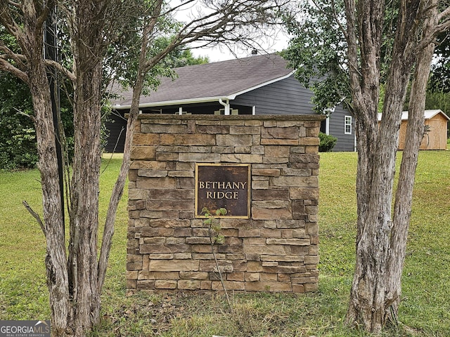 community / neighborhood sign featuring a lawn