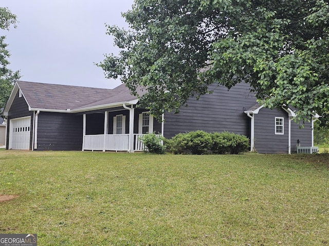 exterior space with a garage, a porch, and a front lawn