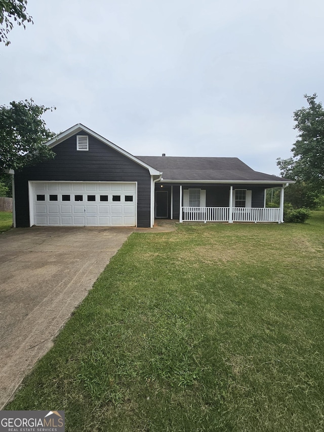view of front of home featuring a porch, an attached garage, concrete driveway, and a front lawn