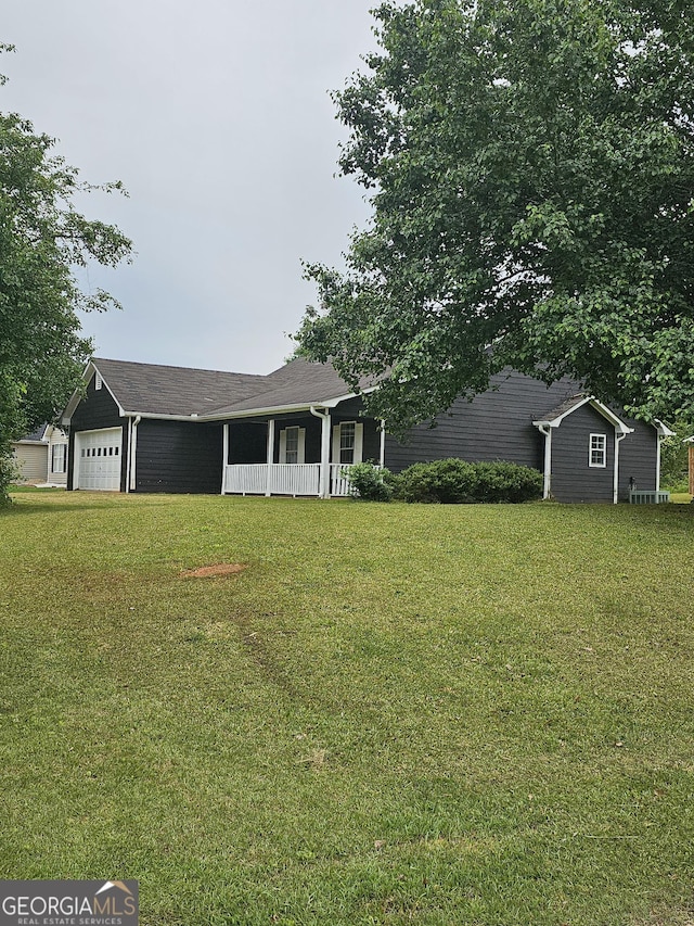 ranch-style home with a garage, a porch, and a front yard