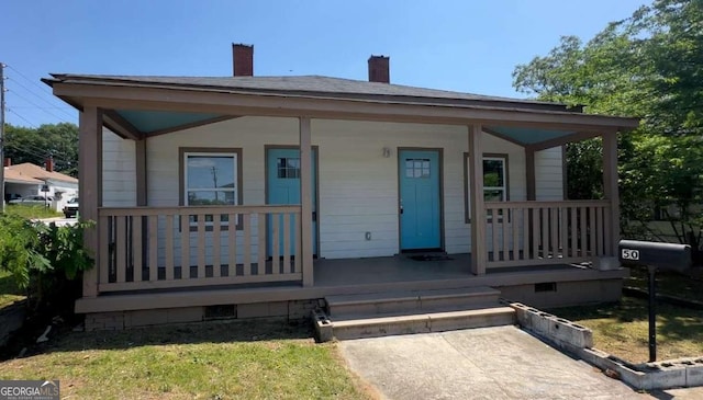 50 Ivy St, Porterdale, GA 30014 - bungalow-style house with a chimney and a porch