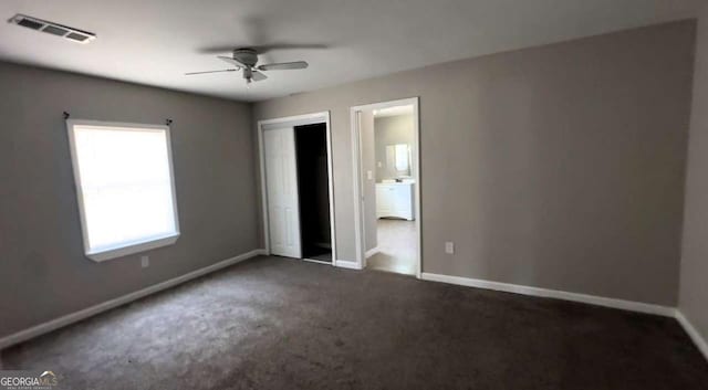 50 Ivy St, Porterdale, GA 30014 - unfurnished bedroom with carpet flooring, a ceiling fan, baseboards, visible vents, and a closet