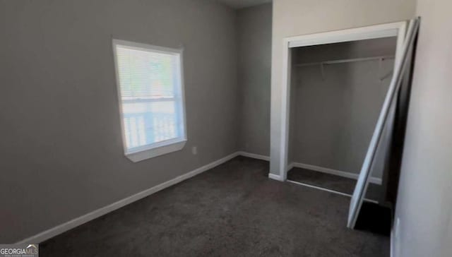 50 Ivy St, Porterdale, GA 30014 - unfurnished bedroom featuring dark carpet, baseboards, and a closet