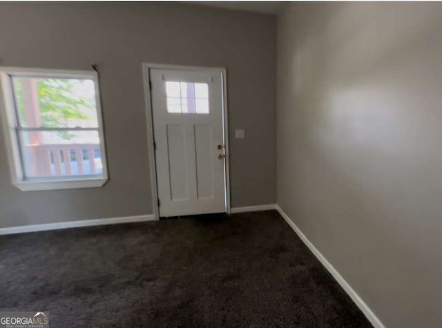 50 Ivy St, Porterdale, GA 30014 - foyer entrance with baseboards and dark carpet