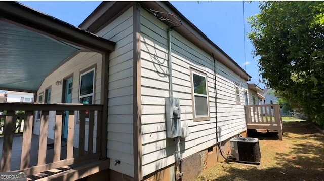 50 Ivy St, Porterdale, GA 30014 - view of side of property with central air condition unit, a wooden deck, and crawl space