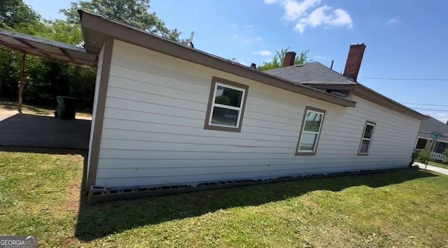 50 Ivy St, Porterdale, GA 30014 - view of side of property with a lawn and a chimney