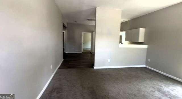 50 Ivy St, Porterdale, GA 30014 - unfurnished room with baseboards and dark colored carpet