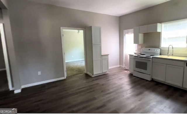 50 Ivy St, Porterdale, GA 30014 - kitchen featuring a sink, light countertops, white electric stove, and dark wood-style floors