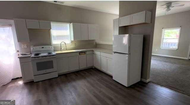 50 Ivy St, Porterdale, GA 30014 - kitchen featuring a ceiling fan, white appliances, light countertops, white cabinets, and a sink