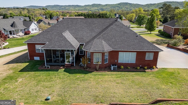 51 Montview Ct, Ringgold, GA 30736 - back of house featuring roof with shingles, brick siding, a sunroom, a mountain view, and a yard