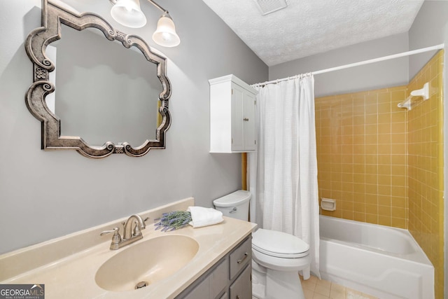 bathroom with visible vents, tile patterned flooring, vanity, toilet, and a textured ceiling