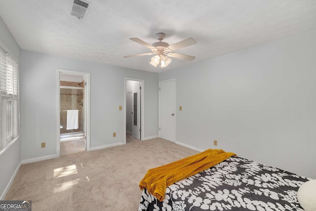 carpeted bedroom featuring a textured ceiling, baseboards, visible vents, and ceiling fan