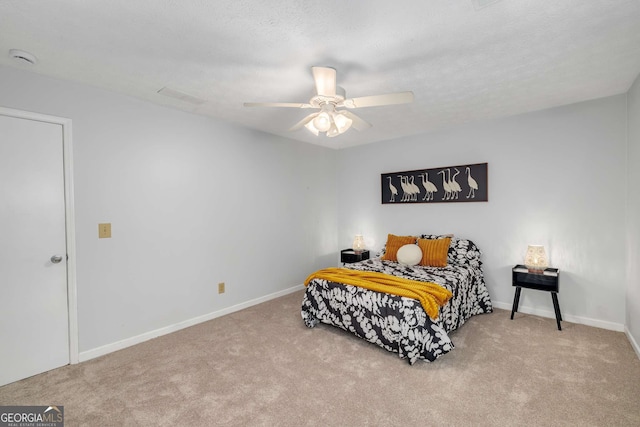 carpeted bedroom featuring baseboards, ceiling fan, and visible vents