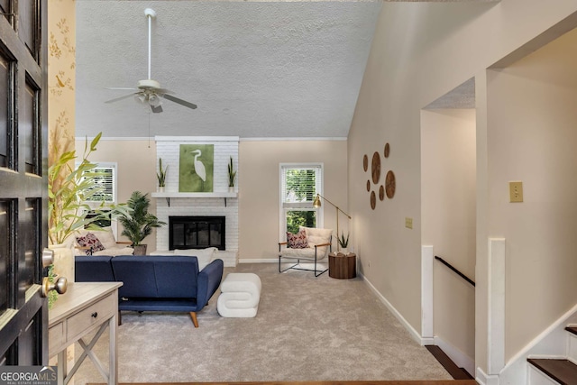 living room featuring carpet floors, a brick fireplace, baseboards, a textured ceiling, and a ceiling fan