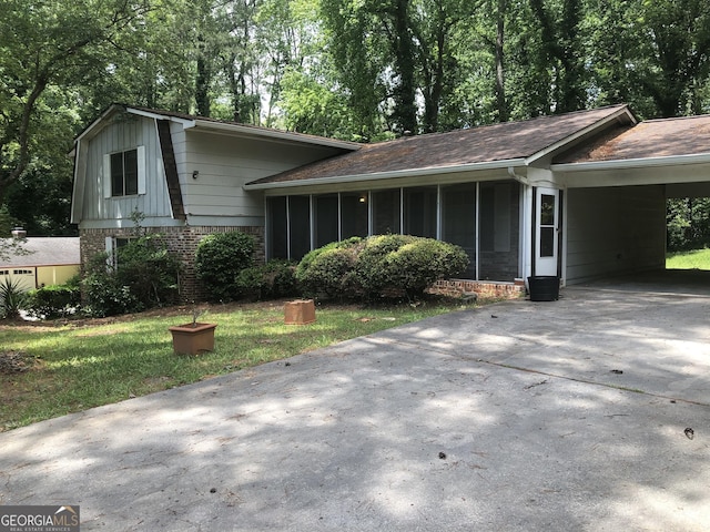 2017 Pine Cone Dr SW, Atlanta, GA 30331 - split level home with a sunroom, brick siding, concrete driveway, and a carport